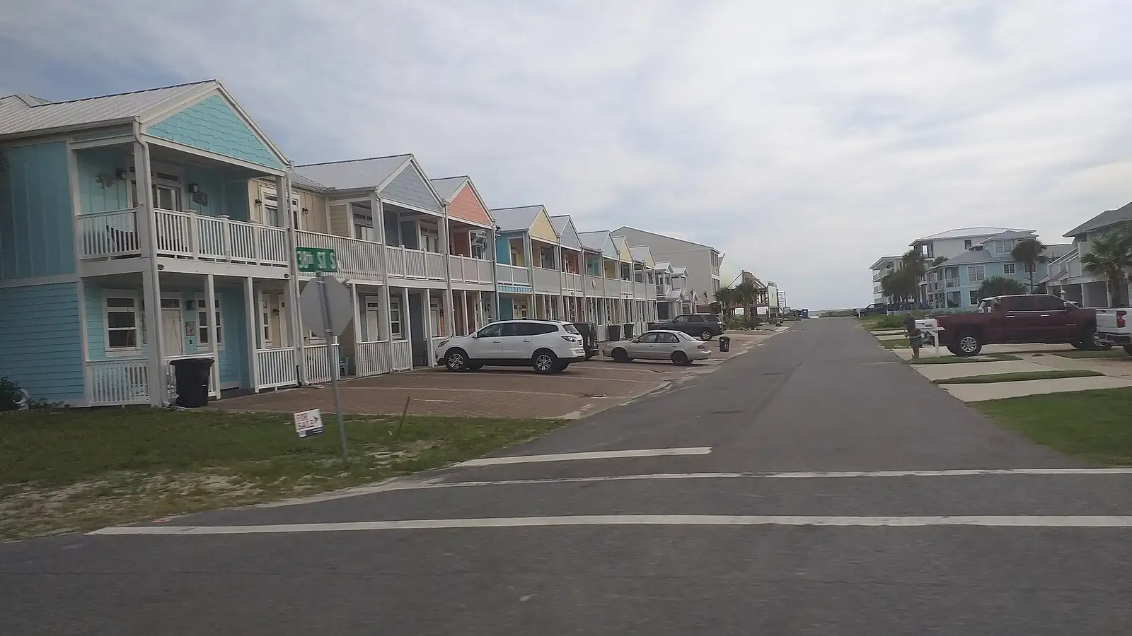 Colorful raised beach townhomes along a street in Mexico Beach, Florida