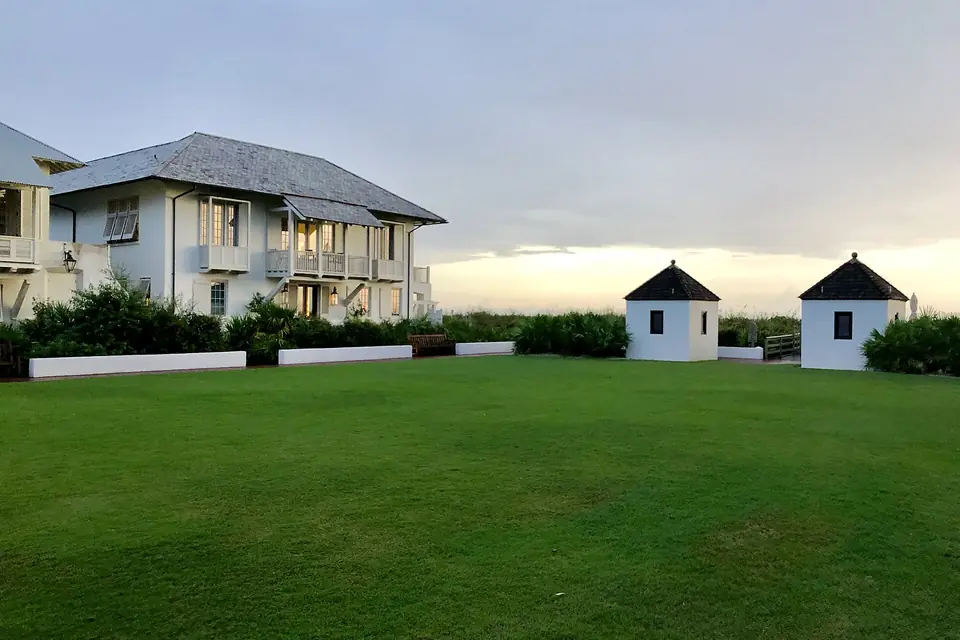 Beach houses facing a green lawn in Rosemary Beach, Florida