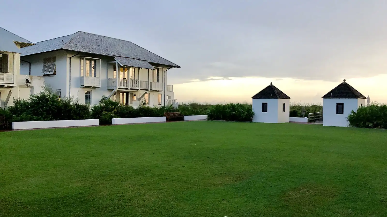 Beach houses facing a green lawn in Rosemary Beach, Florida